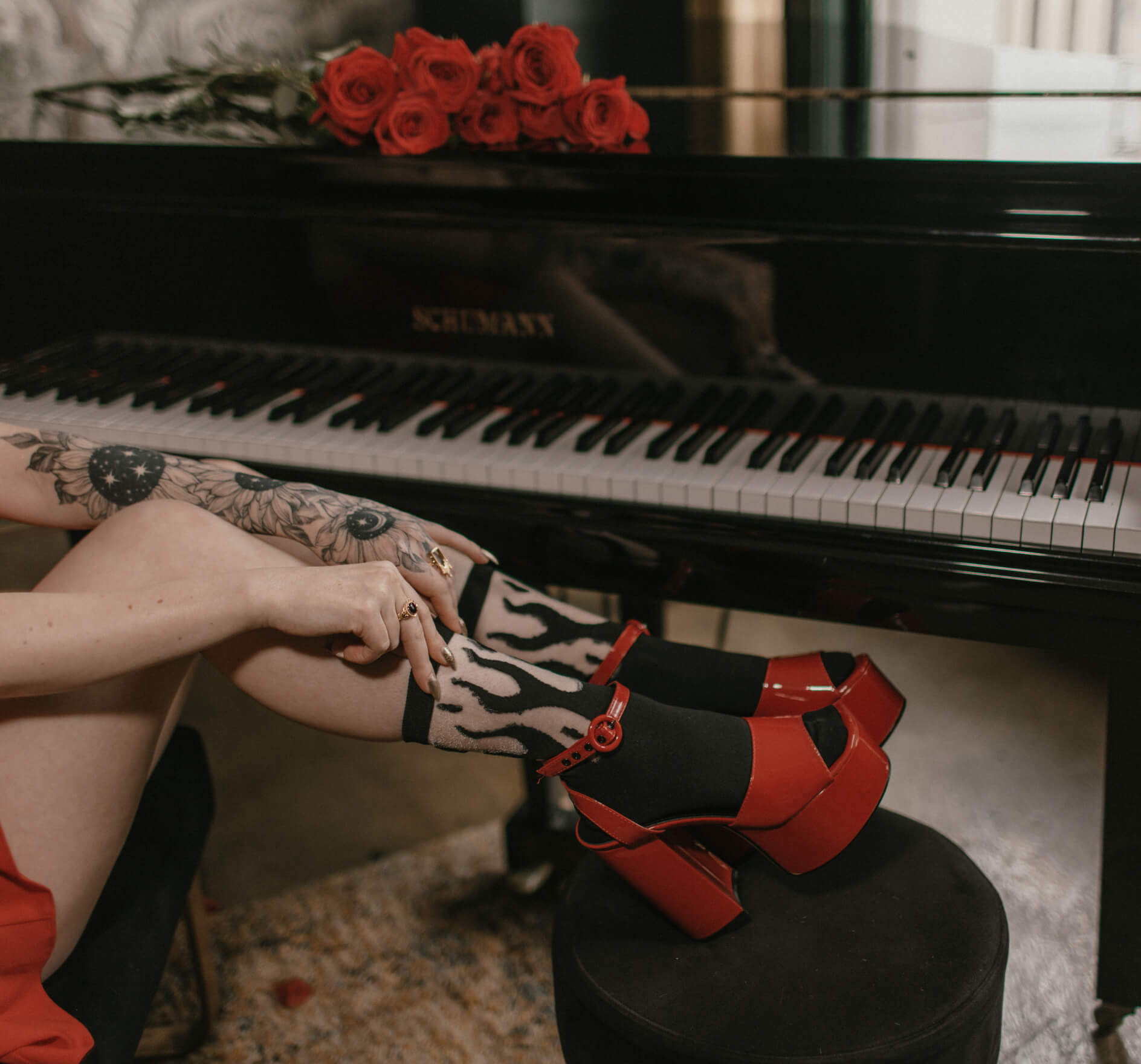 Sheer socks with a black flame pattern for alternative fashion. Shown worn with heels.