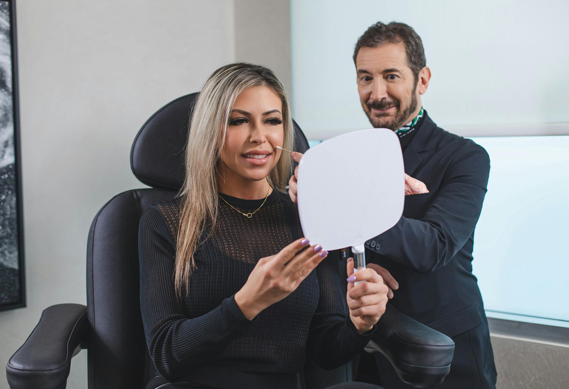 Doctor and woman looking into a mirror