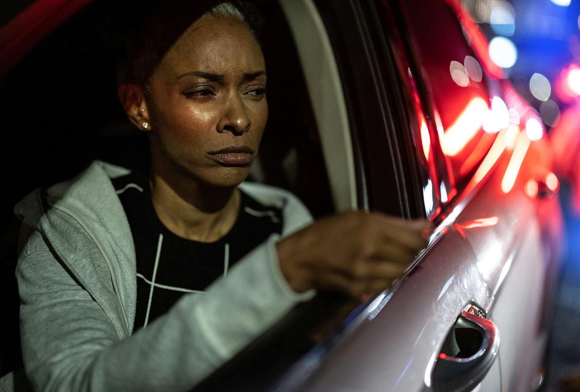 Woman giving her license to a police officer