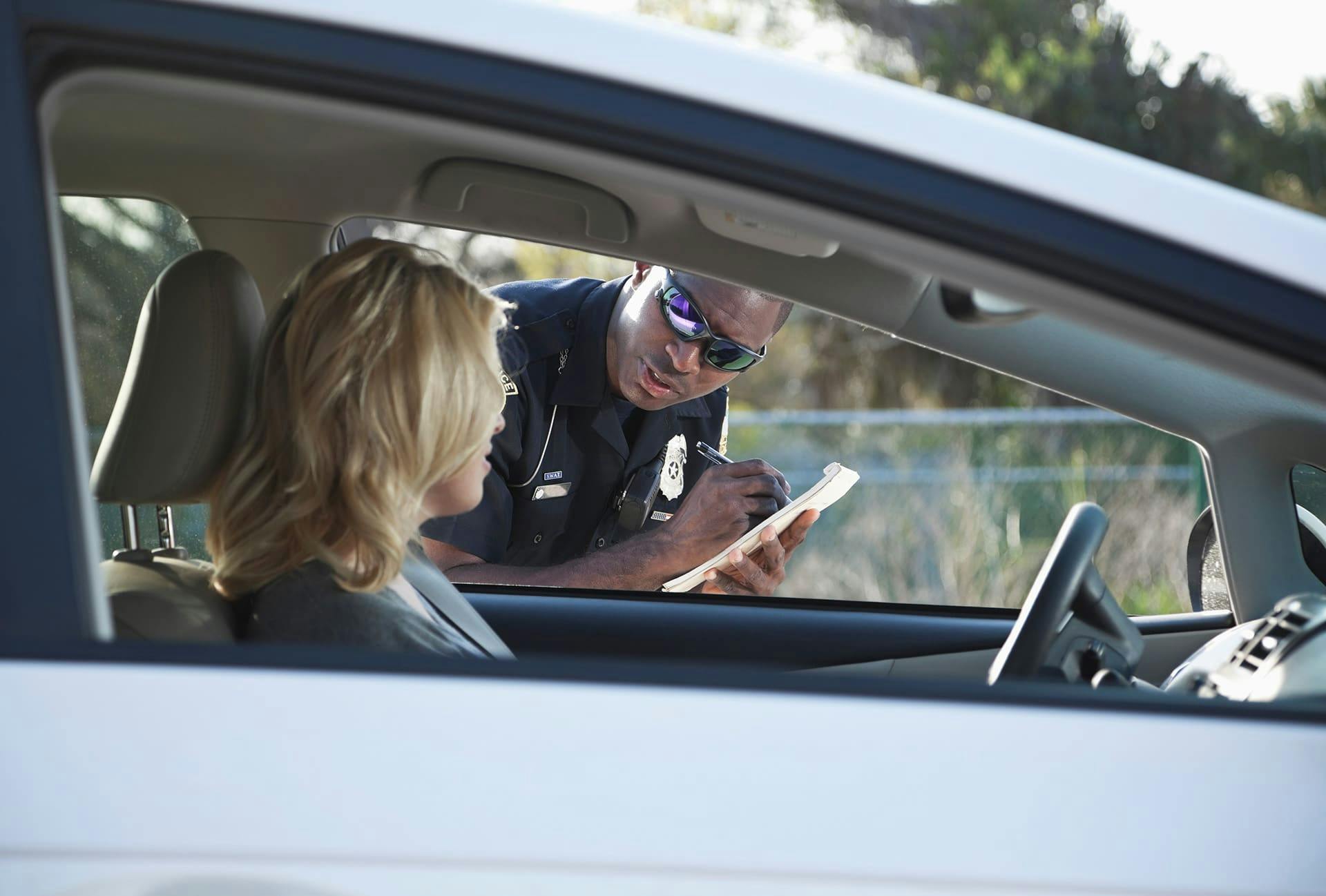 Police officer writing a woman a ticket