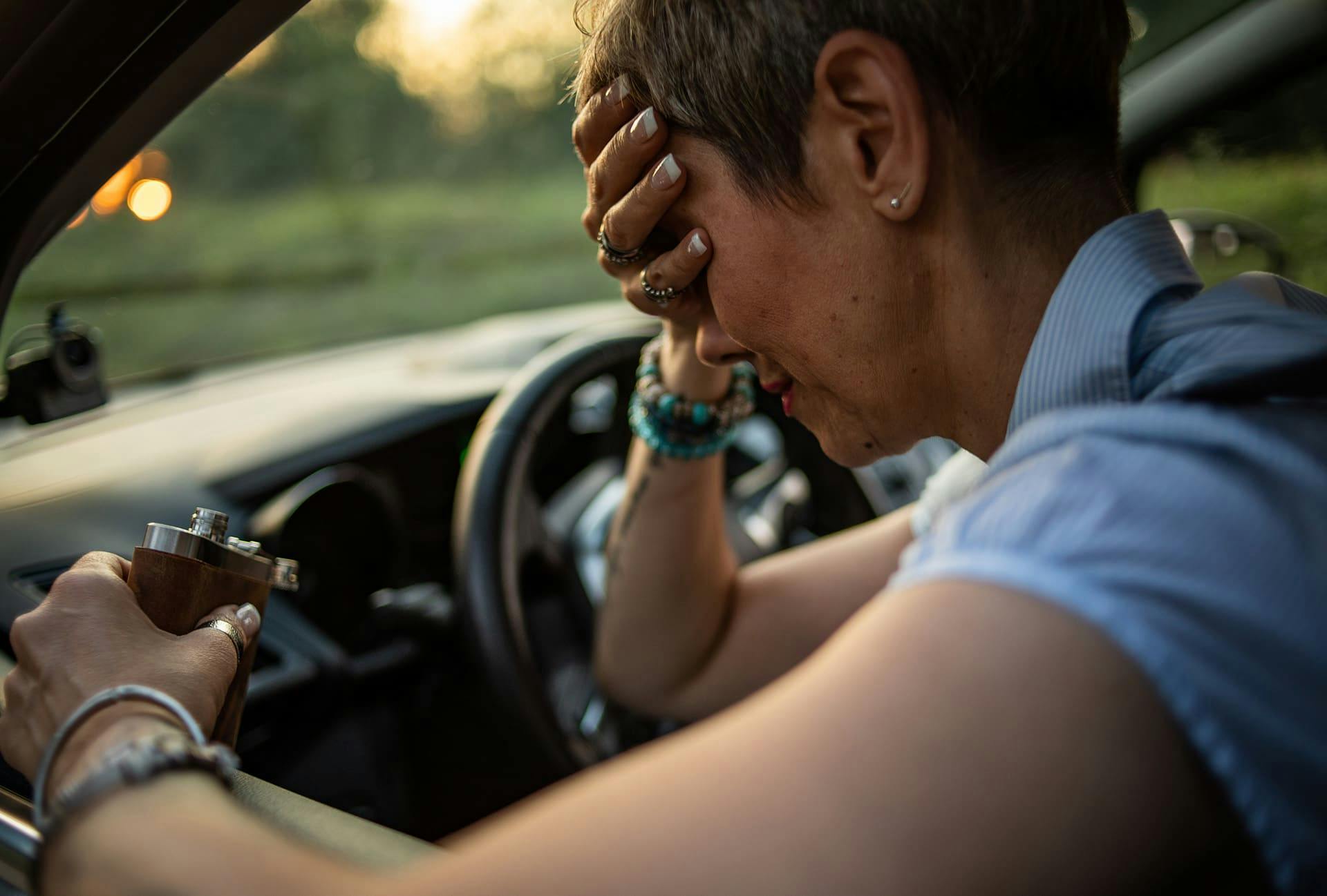Woman drinking and driving.