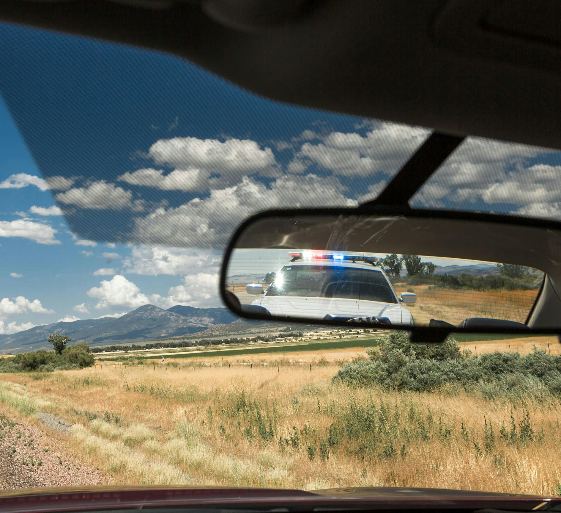 Police car in rear view mirror