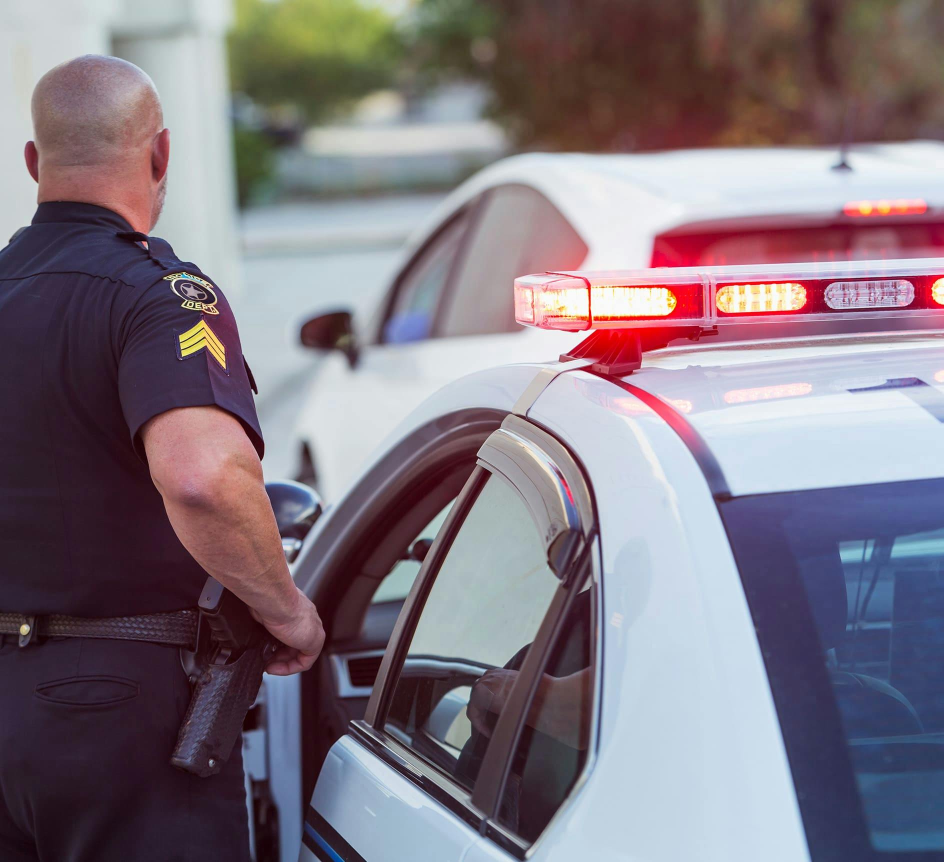 A policeman at his car