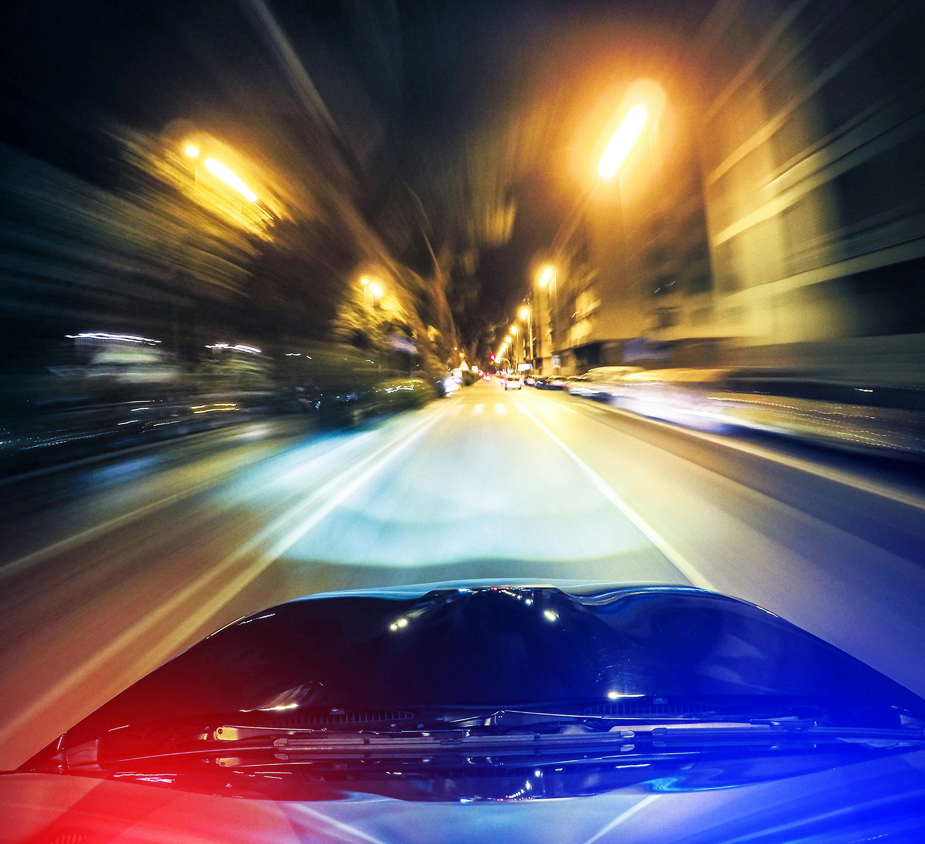 Blurry view from a cop car with lights on