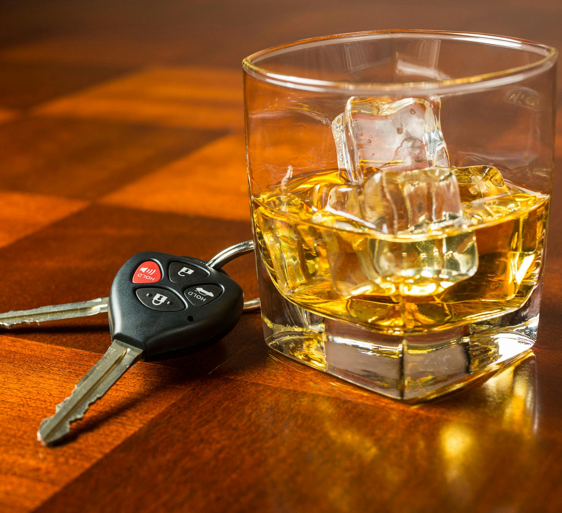 keys next to a glass of alcohol