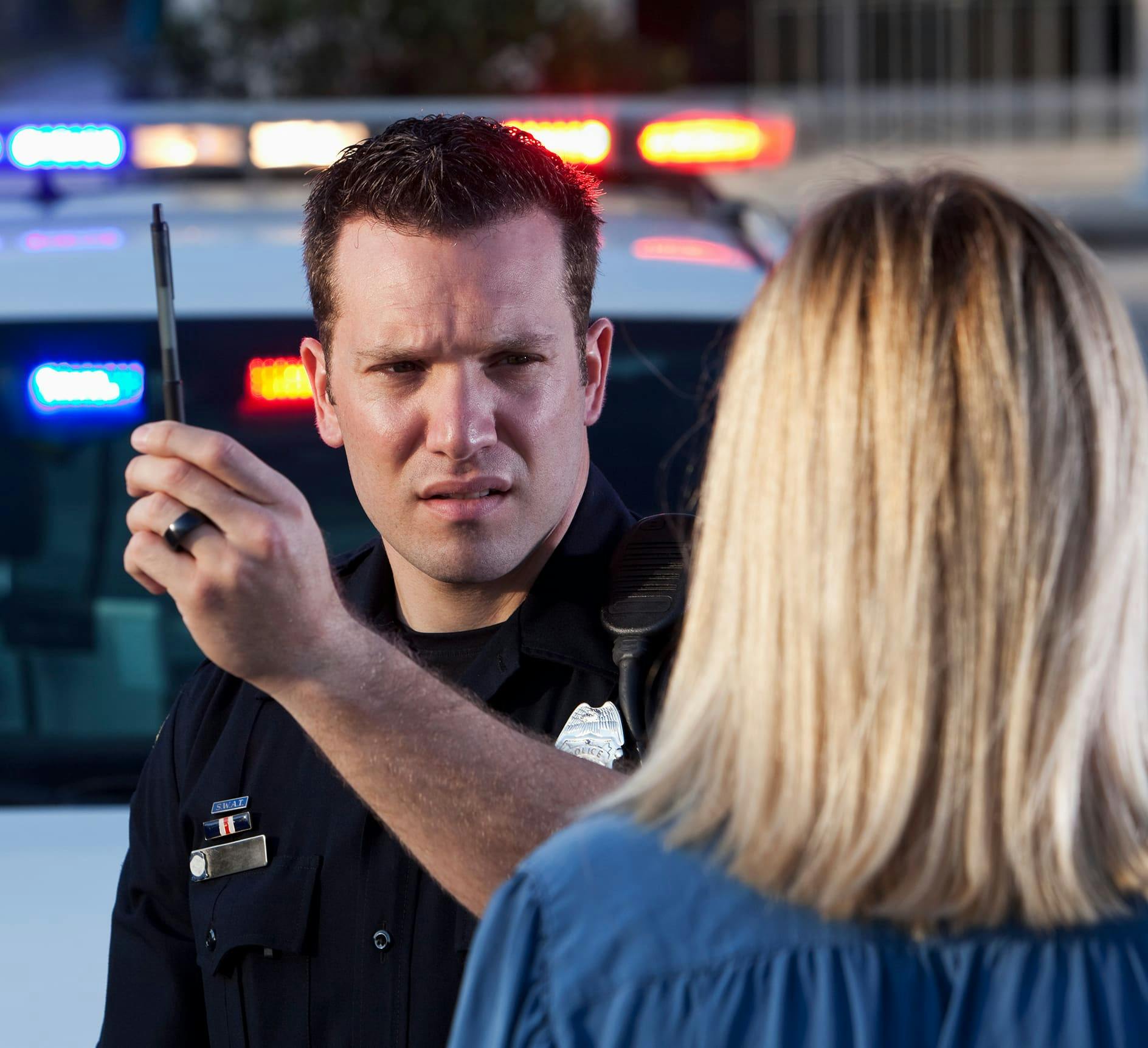 Police officer doing a sobriety test on a woman