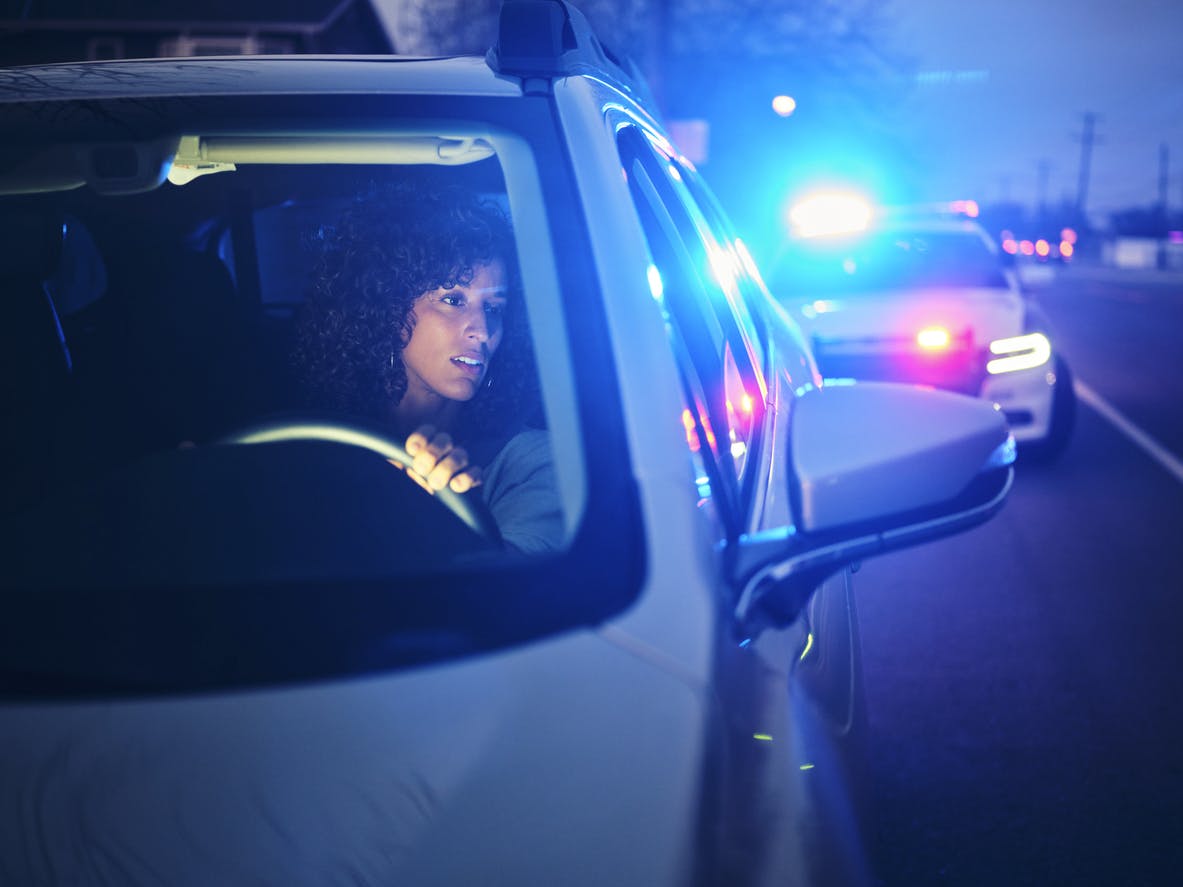 Woman getting pulled over by the cops at night