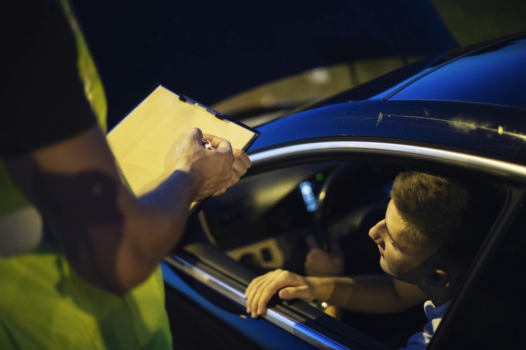 Man getting pulled over by a police officer.