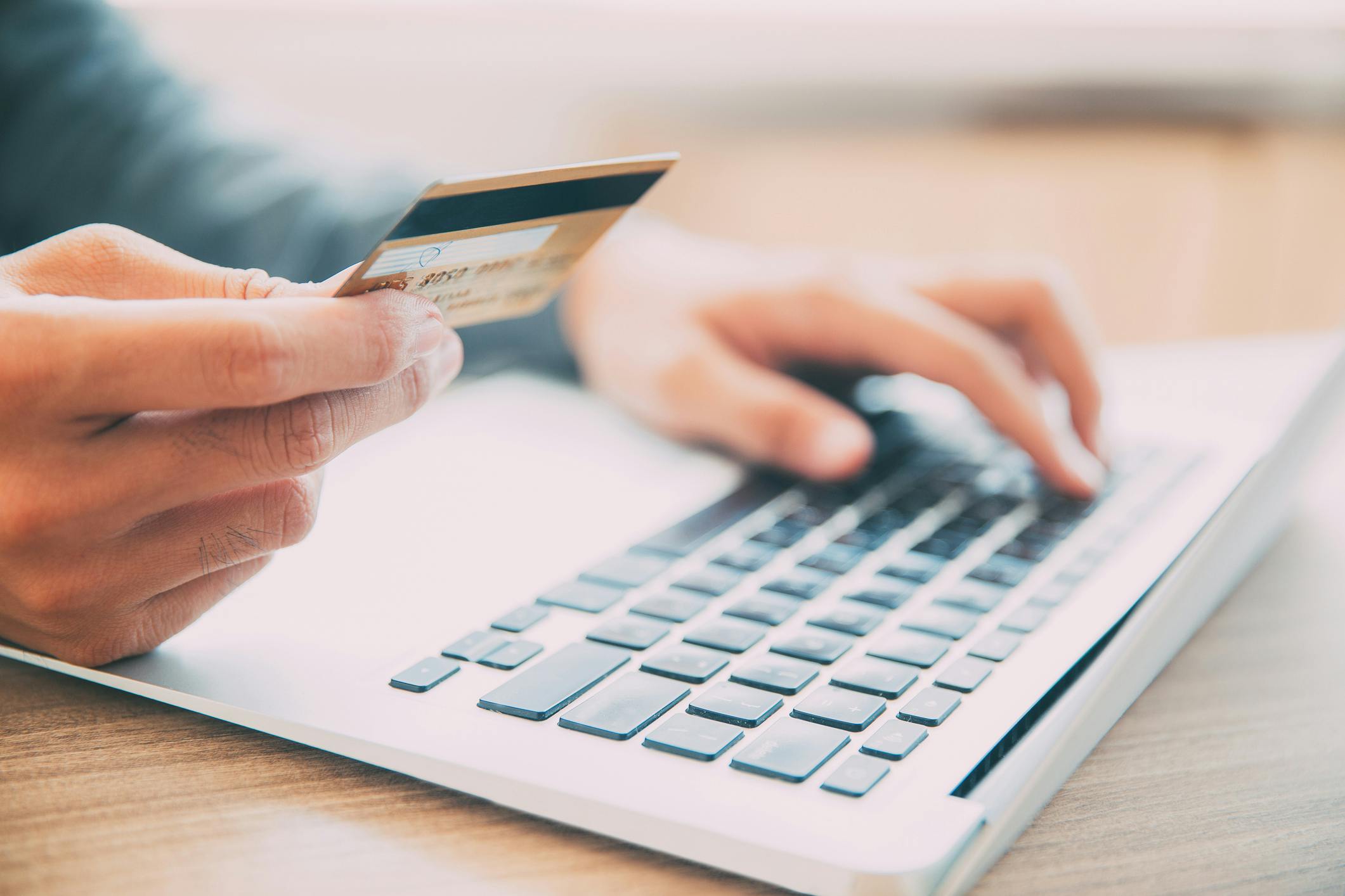 man holding credit card making an online payment