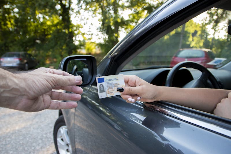 Person handing a officer their ID