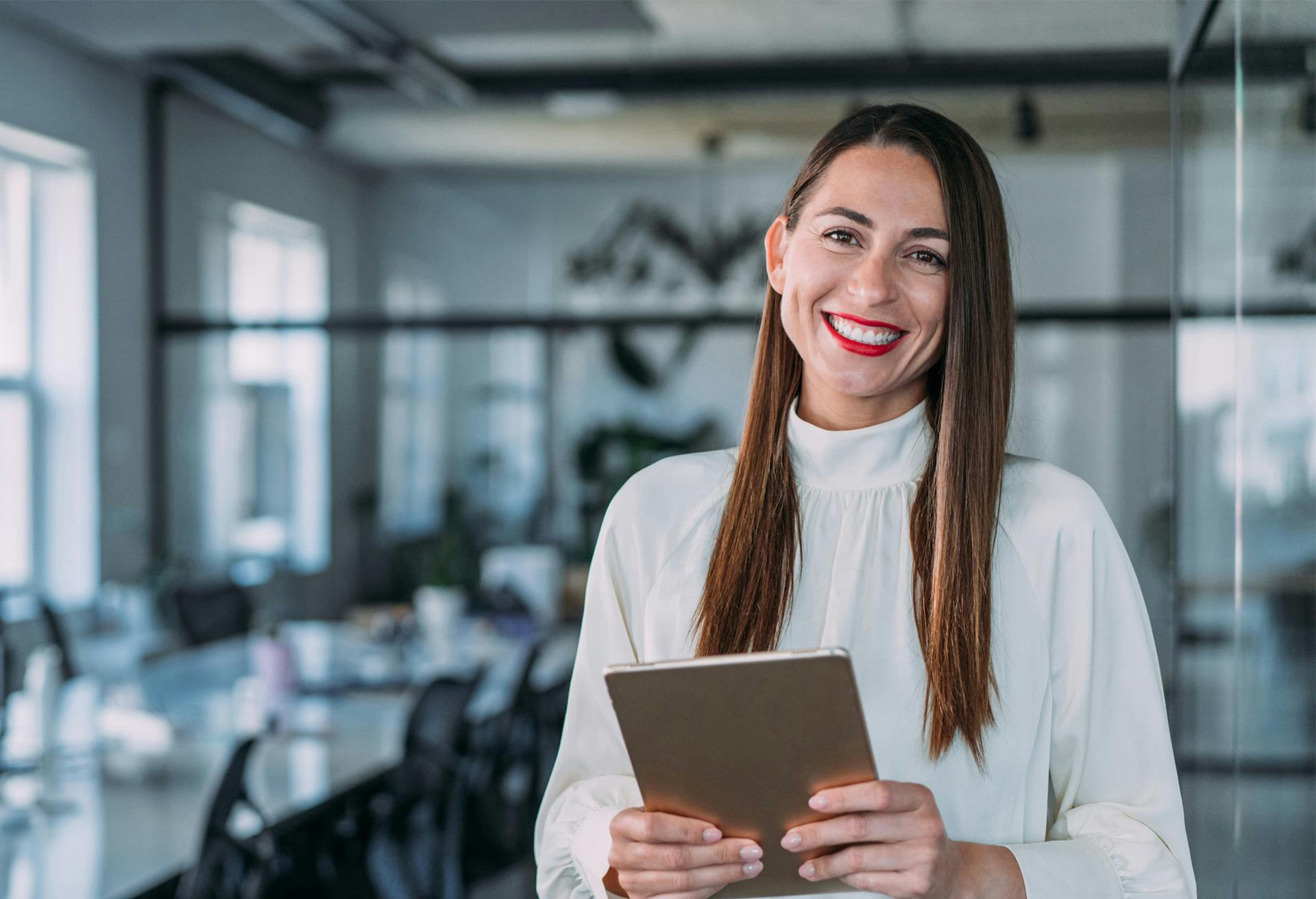 A woman holding a notepad smiling