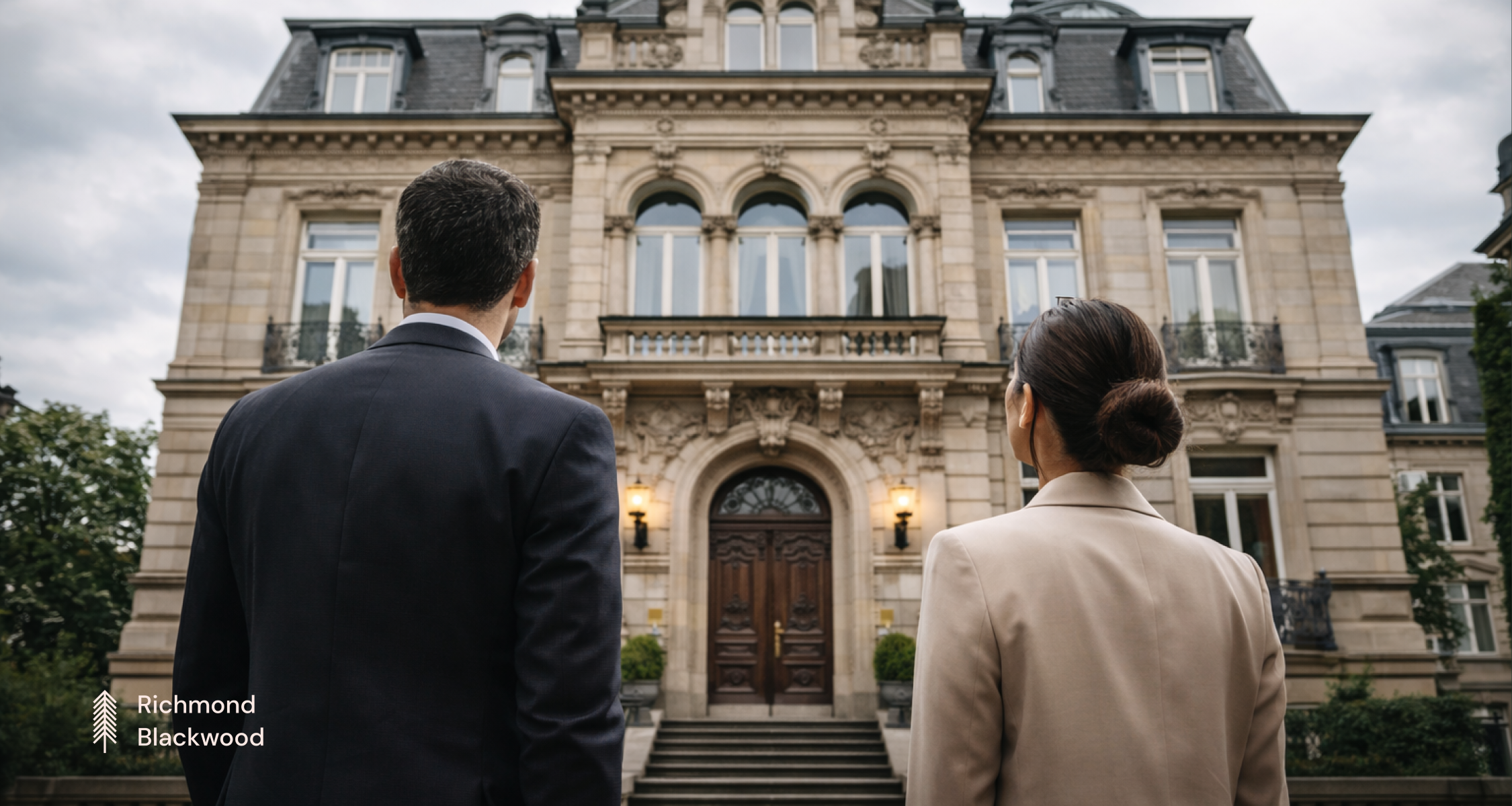Two business professionals walking side by side toward a grand European ...