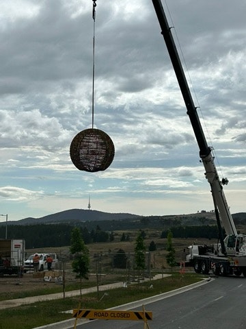 Image for A crane installs Benjamin Shine's sculpture 'Everchange' in Denman Prospect.