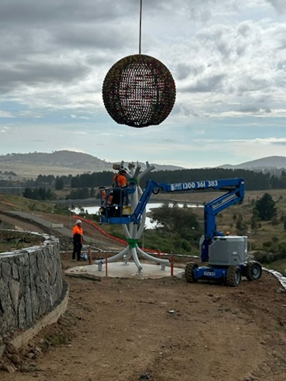 Image for A crane installs Benjamin Shine's sculpture 'Everchange' in Denman Prospect.