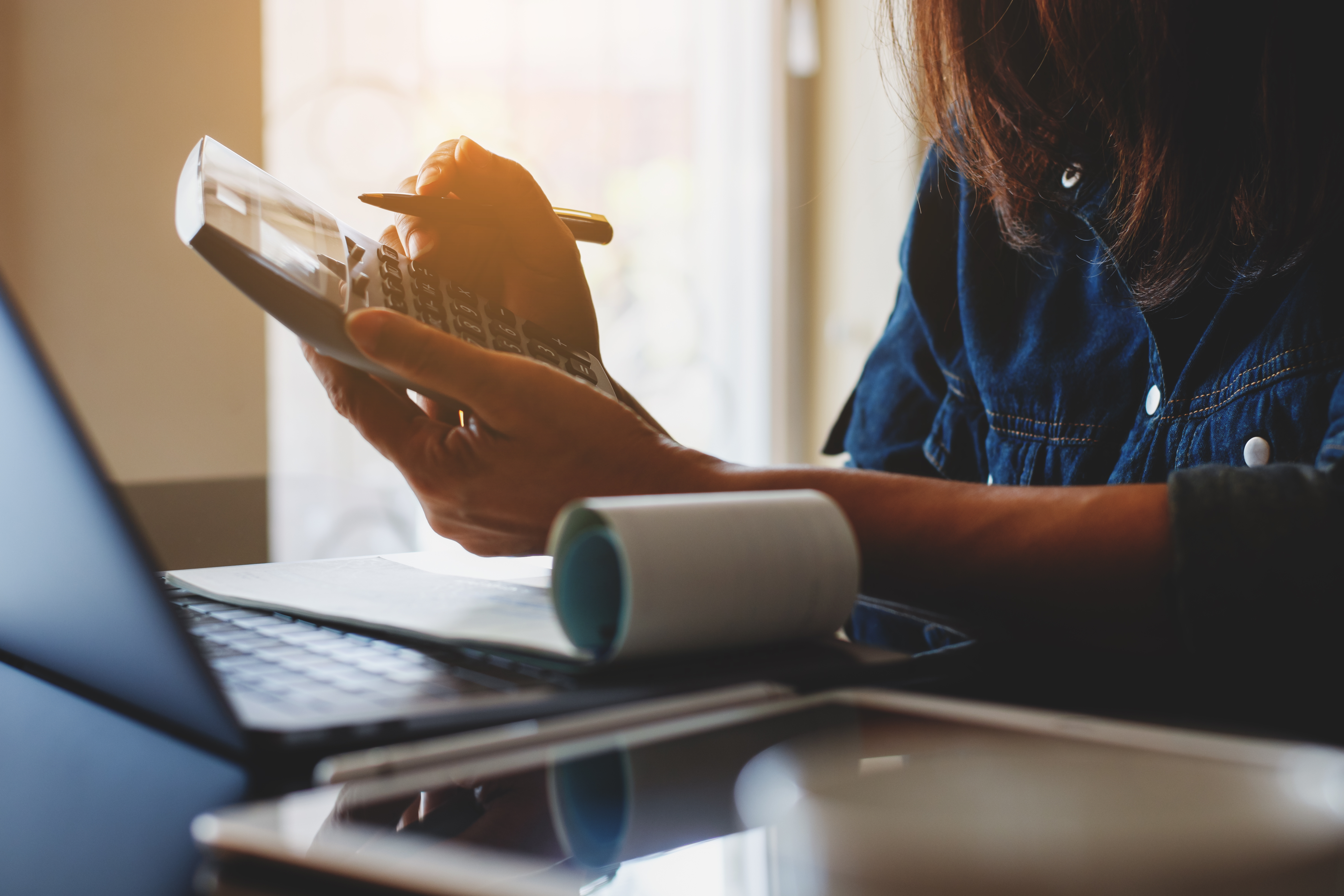 A businesswoman calculating business expenses.