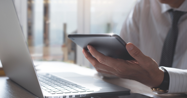 employee looks at tablet