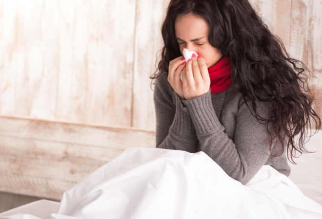 A woman in bed sick with the flu