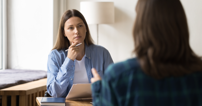 A female HR manager having a discussion with a female employee about employment termination.