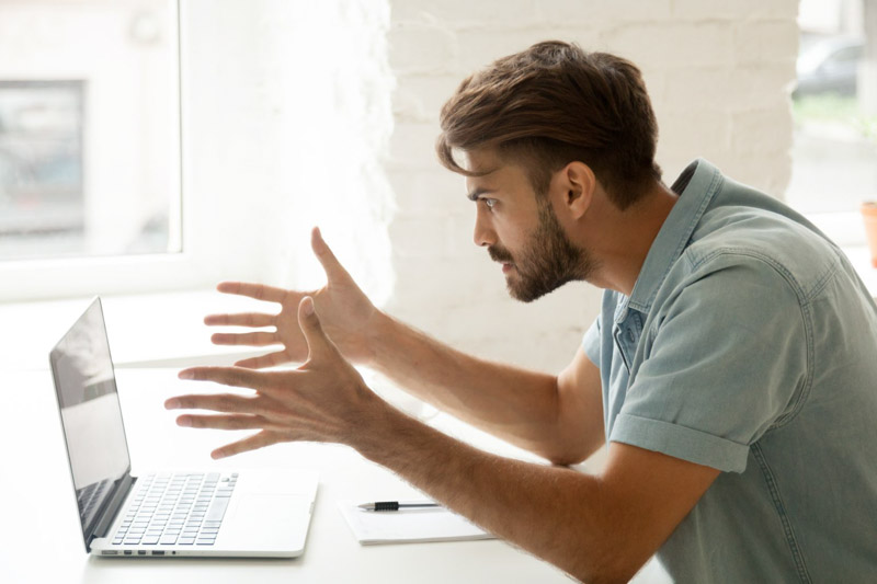 Man frustrated at laptop