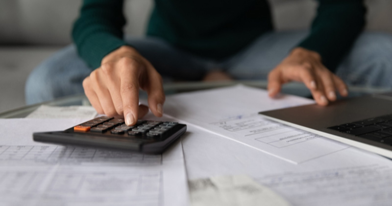 Male adding taxes up on calculator