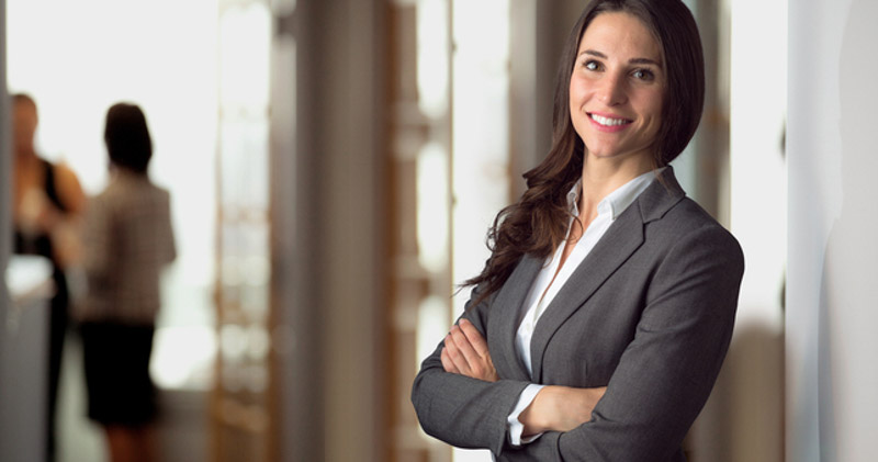 Happy female legal employee with arms crossed