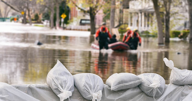 rescue workers walking through flooded town