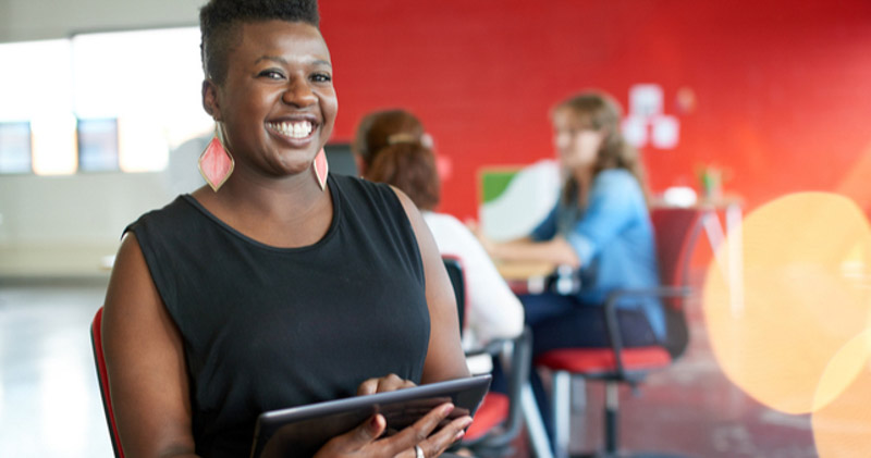 smiling female office worker using tablet