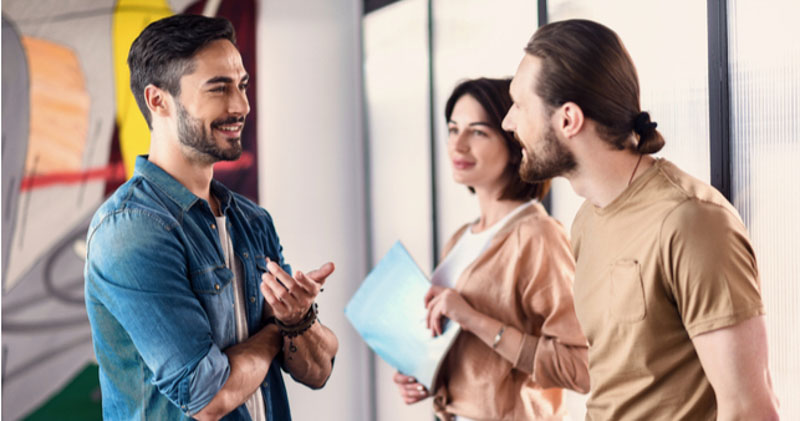 young casually dressed coworkers catching up