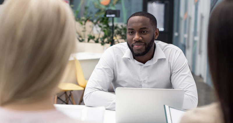 young corporate worker meets with female colleagues outside