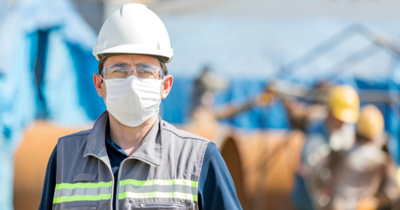 construction worker on building site wearing face mask