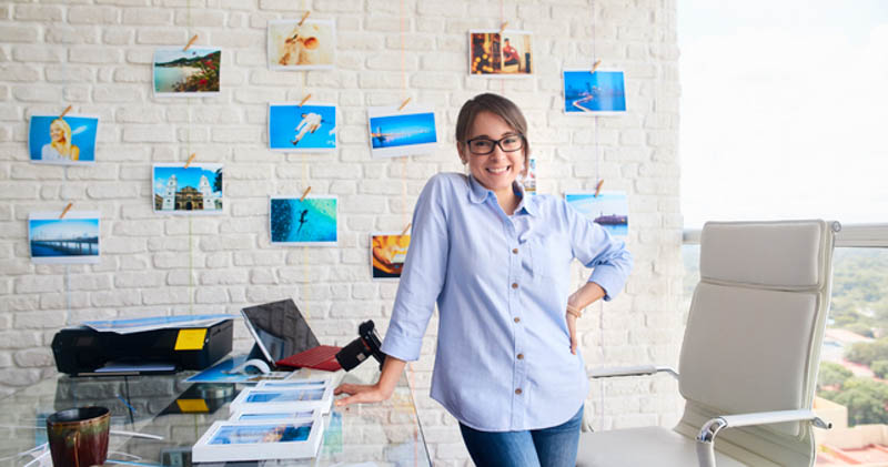 friendly female travel agent stands in sunny office