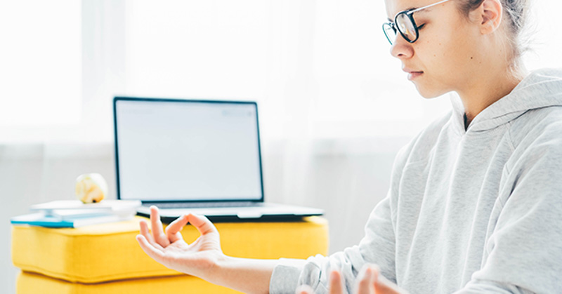 remote worker meditates quietly in sunny room