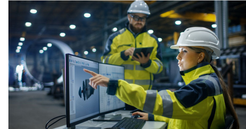female engineer points out data on computer to male colleague