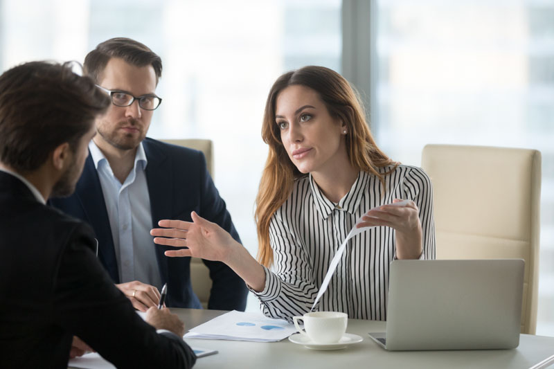 female hr worker has tough conversation with male employee in meeting room