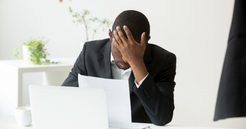 Corporate employee is flustered and upset at meeting table