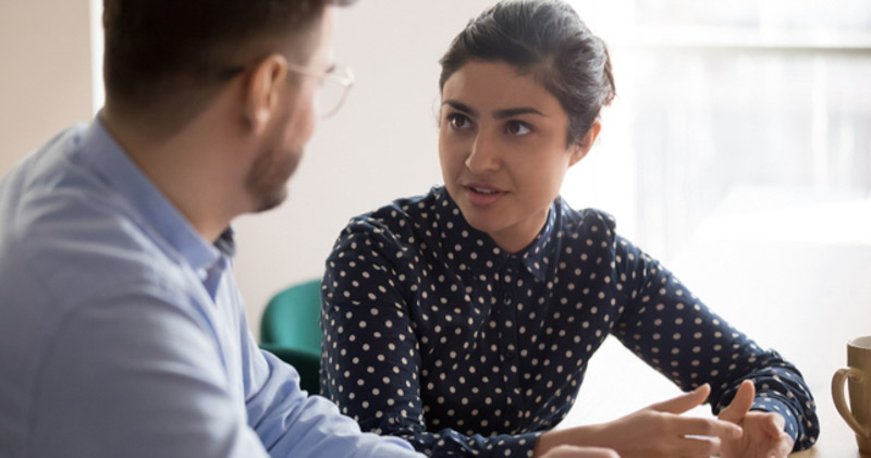 female employee discusses with male colleague