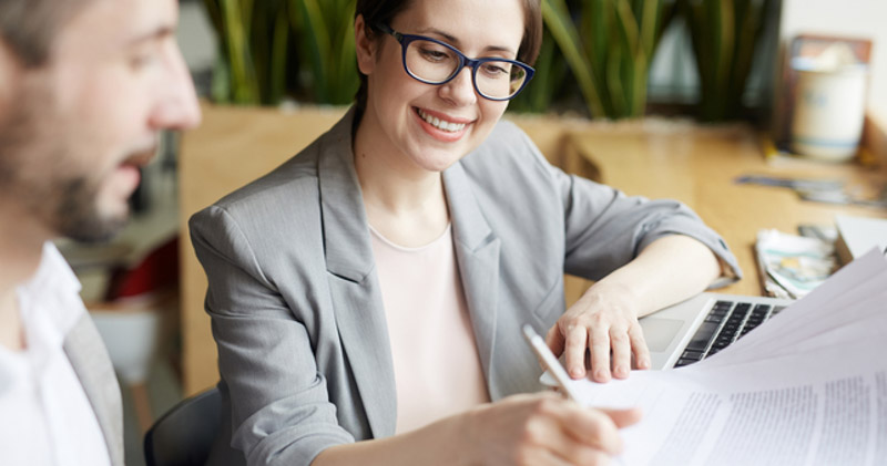 corporate employees examine paperwork together