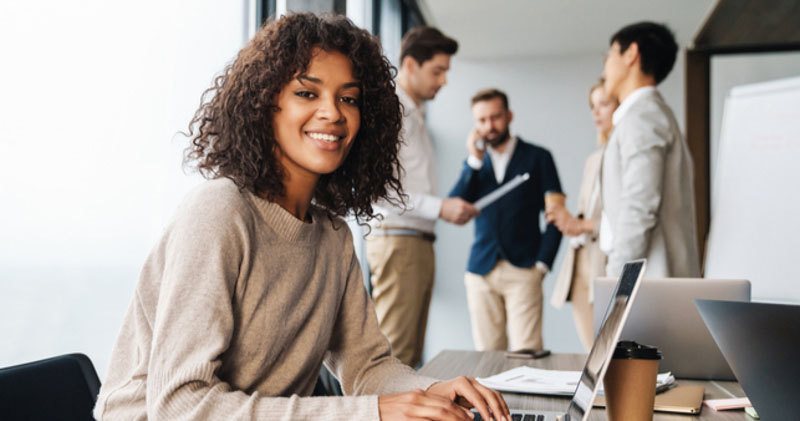 happy female employee in modern work space