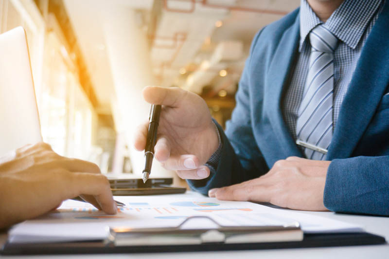 corporate man with fountain pen examines sheet