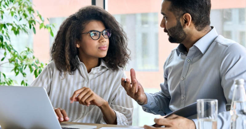 female and male coworker discussion in meeting room