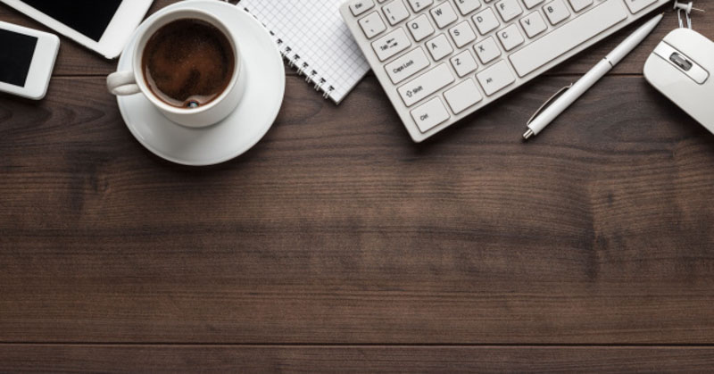 brown table with coffee and keyboard