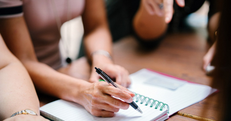 female fills out work diary