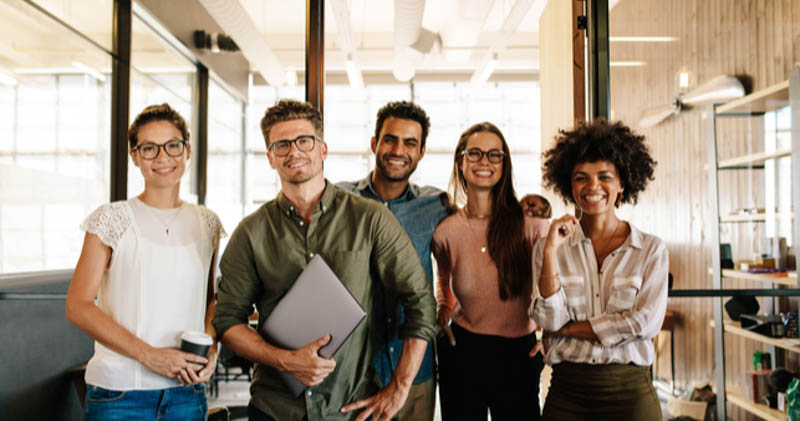 diverse employees stand proudly together