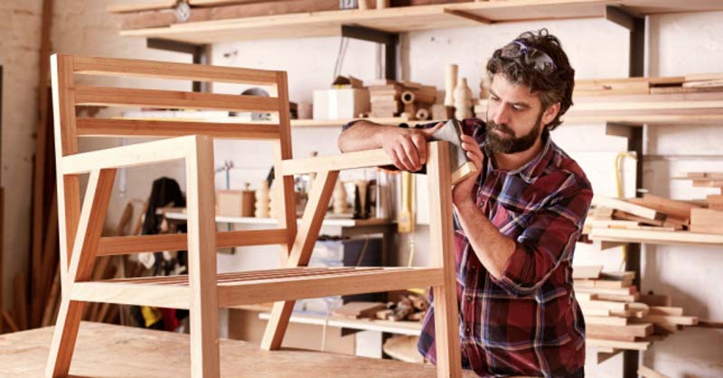 woodworker builds chair frame in workshop