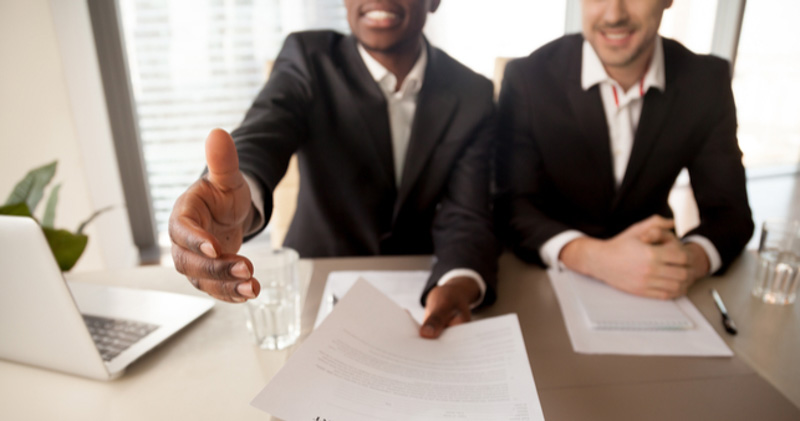 HR managers shake hands with new employee