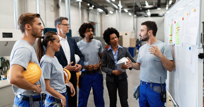 warehouse workers hold safety meeting