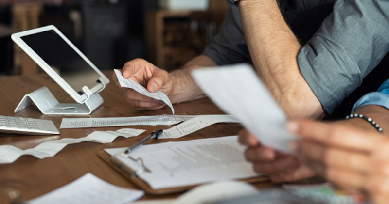 business partners look through receipts