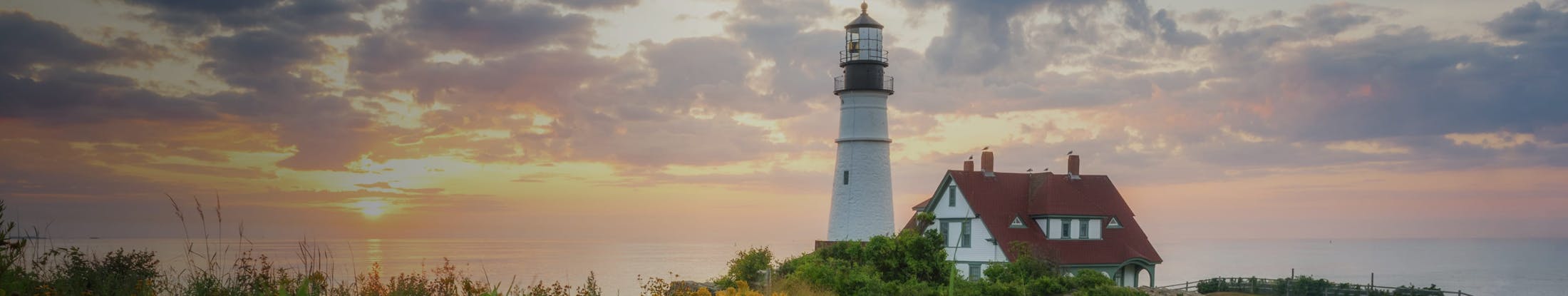 A lighthouse in front of a sunset