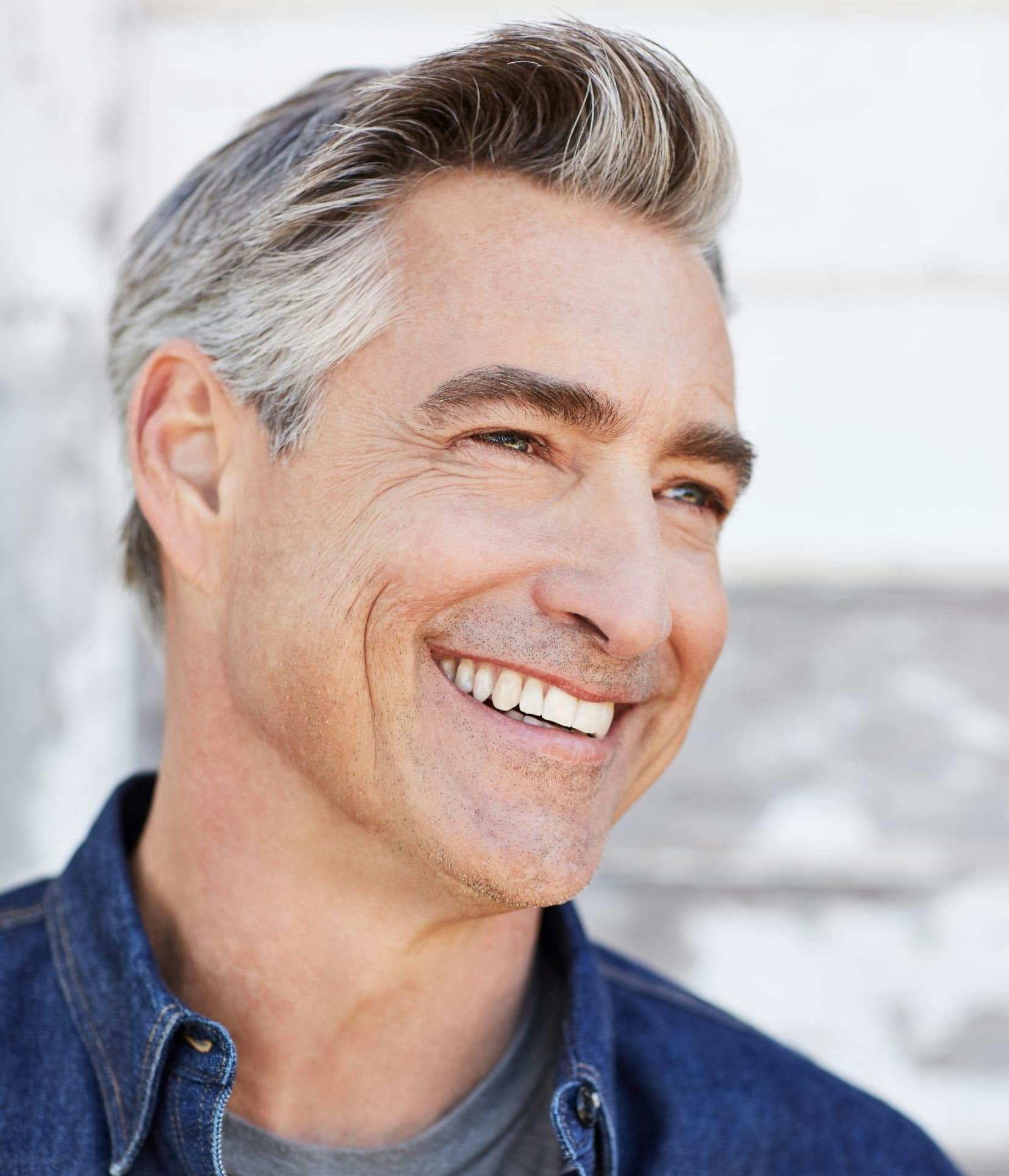Handsome man smiling with salt and pepper hair