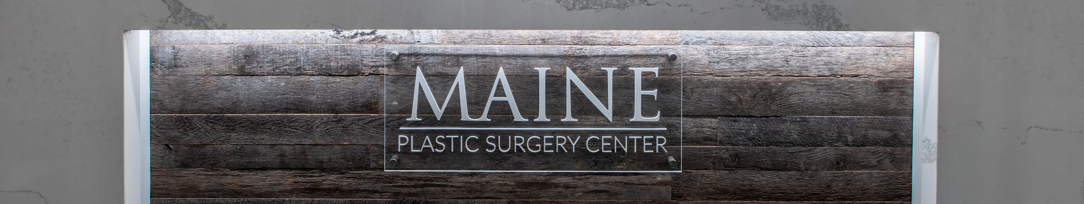 Maine Plastic Surgery sign on a wall